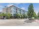 Modern condo building featuring a contemporary design and manicured landscaping at 2958 Syracuse St # 403, Denver, CO 80238
