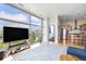 Open-concept living room with modern furnishings, a large window, and a glimpse of the kitchen at 2958 Syracuse St # 403, Denver, CO 80238