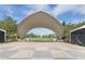 Scenic open-air pavilion and park area with manicured lawn, trees, and concrete checkerboard patio at 2958 Syracuse St # 403, Denver, CO 80238