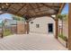 Backyard featuring a wooden deck, gazebo, and well-kept landscaping at 2676 S Lincoln St, Denver, CO 80210