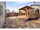 Backyard deck features stairs and an overhead structure in a backyard with stone ground cover and fencing at 2676 S Lincoln St, Denver, CO 80210