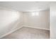 Finished basement room features neutral carpet, natural light and electrical outlets along the walls at 2676 S Lincoln St, Denver, CO 80210