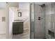 Finished basement bathroom features granite vanity and tiled shower with glass doors and tiled walls at 2676 S Lincoln St, Denver, CO 80210