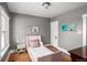 A charming ' room with a cozy pink bed frame, hardwood floors, and wall art at 2676 S Lincoln St, Denver, CO 80210