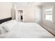 Bright bedroom with natural light featuring hardwood floors, a white door, and neutral walls at 2676 S Lincoln St, Denver, CO 80210