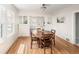 Bright dining room with hardwood floors, a wooden table set, and a view towards the living spaces at 2676 S Lincoln St, Denver, CO 80210