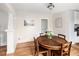 Charming dining room featuring a classic table, hardwood floors, and a view into the kitchen area at 2676 S Lincoln St, Denver, CO 80210