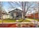 Charming home featuring a well-kept lawn, attractive landscaping, and a welcoming front porch area at 2676 S Lincoln St, Denver, CO 80210