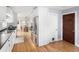 Modern kitchen showcasing white cabinets, stainless steel appliances, dark countertops, and hardwood floors at 2676 S Lincoln St, Denver, CO 80210