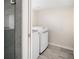 Finished basement laundry room features tile flooring and newer washer and dryer units at 2676 S Lincoln St, Denver, CO 80210