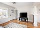 Bright living room features hardwood floors, a large window and a door at 2676 S Lincoln St, Denver, CO 80210