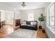 Cozy living room with hardwood floors, neutral paint, a comfy leather sofa and a leafy plant at 2676 S Lincoln St, Denver, CO 80210