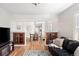 Inviting living room with hardwood floors, wood trim details, and an open view to the dining area at 2676 S Lincoln St, Denver, CO 80210