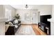 Bright living room with hardwood floors, a large window, and a comfortable leather sofa at 2676 S Lincoln St, Denver, CO 80210