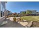 Outdoor living space with a stamped concrete patio, table and chairs, and mature lawn at 20942 E Hampden Pl, Aurora, CO 80013