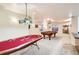 Finished basement with game tables, carpet flooring and decorative lighting fixtures at 20942 E Hampden Pl, Aurora, CO 80013