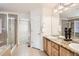 En suite bathroom features double sinks, granite countertops, tile floor, and glass shower enclosure at 20942 E Hampden Pl, Aurora, CO 80013
