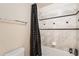 Bathroom with tile surround, shower curtain, and convenient storage for toiletries at 20942 E Hampden Pl, Aurora, CO 80013