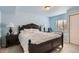 Comfortable bedroom with blue walls, decorative pillows, reading lamps, and natural light at 20942 E Hampden Pl, Aurora, CO 80013