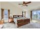 Vaulted bedroom with ceiling fan, two windows, plush carpet and a decorative wooden bed frame at 20942 E Hampden Pl, Aurora, CO 80013