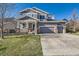 Charming two-story home with a three-car garage and inviting front porch at 20942 E Hampden Pl, Aurora, CO 80013