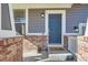 Inviting front door with brick accents and a welcome mat at 20942 E Hampden Pl, Aurora, CO 80013
