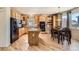 Well-lit kitchen with modern appliances, granite counters, and a breakfast nook at 20942 E Hampden Pl, Aurora, CO 80013