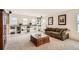 Spacious living room with built in shelves, plush carpet, natural light, and comfortable furniture at 20942 E Hampden Pl, Aurora, CO 80013