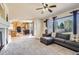 Bright living room with a large window, fireplace, and open access to the kitchen at 20942 E Hampden Pl, Aurora, CO 80013