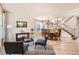 Open concept living and dining area features hardwood floors and stairs to the upper level at 20942 E Hampden Pl, Aurora, CO 80013