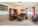 Comfortable home office features a wooden desk, hutch, chair, and natural light from the window at 20942 E Hampden Pl, Aurora, CO 80013