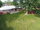 Aerial view of the backyard showcasing the lawn, mature tree, and patio area at 1840 E 84Th Ave, Denver, CO 80229