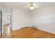 Bright bedroom features hardwood floors, ceiling fan, and closet for storage at 1840 E 84Th Ave, Denver, CO 80229