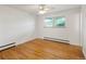 Bedroom boasts natural light from the window and sleek hardwood floors at 1840 E 84Th Ave, Denver, CO 80229