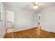 Bedroom with wood floors and ceiling fan provides access to bathroom at 1840 E 84Th Ave, Denver, CO 80229