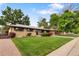 Charming ranch-style home featuring a well-maintained lawn and mature trees in a desirable neighborhood at 1840 E 84Th Ave, Denver, CO 80229