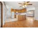 Bright eat-in kitchen with white appliances, wooden cabinets, and hardwood floors at 1840 E 84Th Ave, Denver, CO 80229
