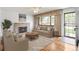 Inviting living room with a cozy fireplace, a large window, and stylish furnishings at 1840 E 84Th Ave, Denver, CO 80229