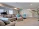 Finished basement featuring a comfortable sectional, accent chair and a wooden table at 527 Felicity Loop, Castle Rock, CO 80109