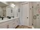Bright bathroom features double sink vanity with white cabinets, marble countertop, and modern fixtures at 527 Felicity Loop, Castle Rock, CO 80109