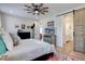 Comfortable bedroom with ceiling fan, stylish decor, and sliding barn door leading to the bathroom at 527 Felicity Loop, Castle Rock, CO 80109