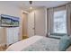 Bedroom showcasing a decorative cabinet with TV, large window with curtains and a small couch at 527 Felicity Loop, Castle Rock, CO 80109
