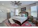 Cozy bedroom with a plush bed, decorative rug, ceiling fan, and ample natural light at 527 Felicity Loop, Castle Rock, CO 80109