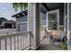 Cozy covered front porch with white railing and gray trim, perfect for relaxing outdoors at 527 Felicity Loop, Castle Rock, CO 80109