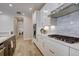 Stylish kitchen with white cabinets, stainless steel appliances, a gas cooktop, and marble countertops at 527 Felicity Loop, Castle Rock, CO 80109