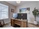 Bright office with large monitors, wooden desk, office chair, area rug, and leafy potted plant at 527 Felicity Loop, Castle Rock, CO 80109
