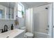 Bright bathroom showcasing a shower-tub with white subway tile, vanity with a dark faucet, and a window at 2829 W 53Rd Ave # 104, Denver, CO 80221