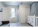 Well-lit Bedroom featuring a dresser with changing table and closet with sliding doors at 2829 W 53Rd Ave # 104, Denver, CO 80221