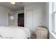 Cozy bedroom features a neatly made bed, a dresser, and closet with sliding doors at 2829 W 53Rd Ave # 104, Denver, CO 80221