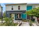 Inviting townhouse with covered porch, chairs, and colorful exterior accents at 2829 W 53Rd Ave # 104, Denver, CO 80221